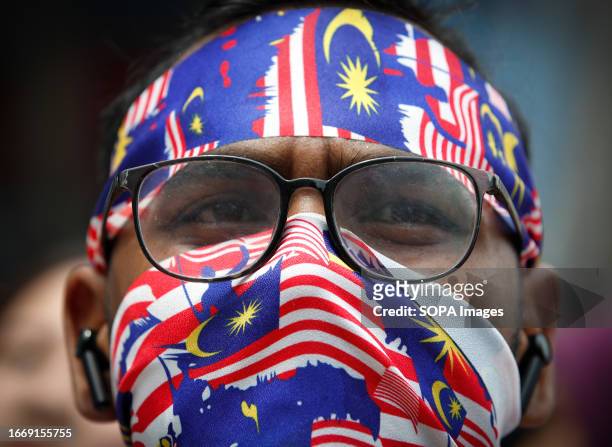 Protester wears headband and mask during the Save Malaysia rally. Protesters rally against the controversial decision to halt the corruption trial of...
