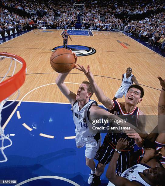 Shawn Bradley of the Dallas Mavericks covered by Yao Ming of the Houston Rockets goes up for the shot during the game at American Airlines Center on...