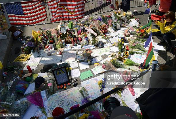 Flowers, medals, stuffed animals, letters and other items at the impromptu memorial at the corner of Boylston and Berkeley Streets for the victims of...