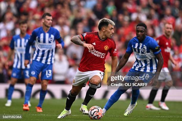 Manchester United's Argentinian defender Lisandro Martinez looks to play a pass during the English Premier League football match between Manchester...