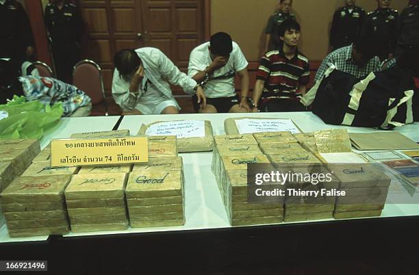 Drug traffickers turned over to the press by the Thai police after being caught with 74 kilos of pure heroin..