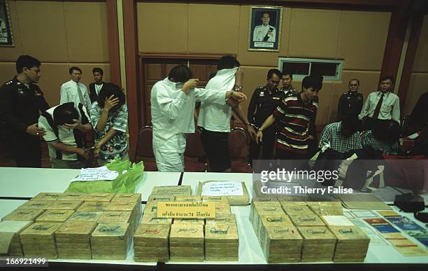 Drug traffickers turned over to the press by the Thai police after being caught with 74 kilos of pure heroin..