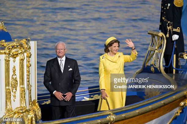King Carl XVI Gustaf of Sweden looks on as Queen Silvia of Sweden waves to the crowds during festivities to celebrate the 50th anniversary of King...