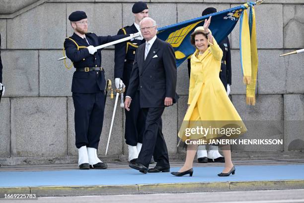 King Carl XVI Gustaf of Sweden looks on as Queen Silvia of Sweden waves to the crowds during festivities to celebrate the 50th anniversary of King...