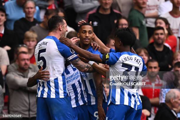 Brighton's Brazilian striker Joao Pedro celebrates with teammates after scoring their third goal during the English Premier League football match...