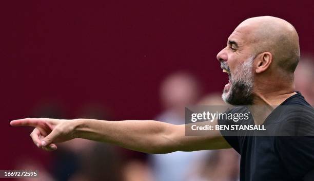 Manchester City's Spanish manager Pep Guardiola shouts instructions to the players from the touchline during the English Premier League football...