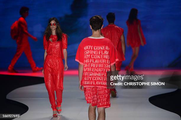 Models present outfits of Coca Cola clothing during the Rio Fashion Week in Rio de Janeiro, Brazil on April 18, 2013. AFP PHOTO / CHRISTOPHE SIMON