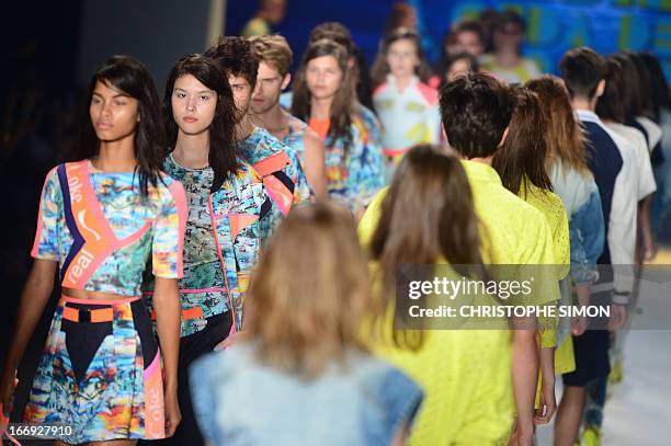 Models present outfits of Coca Cola clothing during the Rio Fashion Week in Rio de Janeiro, Brazil on April 18, 2013. AFP PHOTO / CHRISTOPHE SIMON