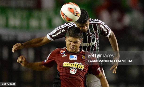 Gum of Brazil’s Fluminense, vies for the ball with Rubem Ramirez of Venezuela’s Caracas FC, during their 2013 Copa Libertadores football match held...