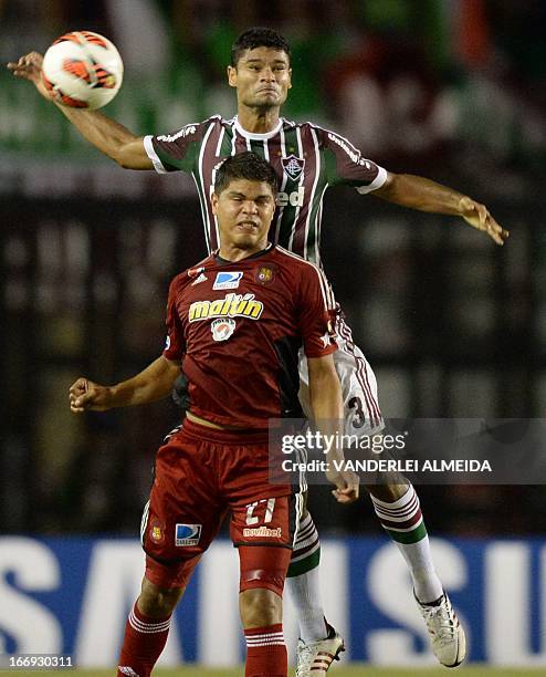 Gum of Brazil’s Fluminense, vies for the ball with Rubem Ramirez of Venezuela’s Caracas FC, during their 2013 Copa Libertadores football match held...