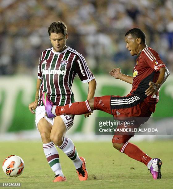 Rafael Sobis of Brazil’s Fluminense, vies for the ball with Jose Quijada of Venezuela’s Caracas FC, during their 2013 Copa Libertadores football...