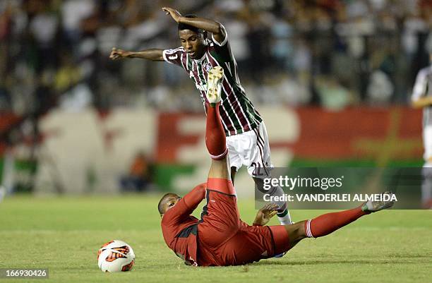 Rayner of Brazil’s Fluminense, vies for the ball with Edgar Jimenez of Venezuela’s Caracas FC, during their 2013 Copa Libertadores football match...