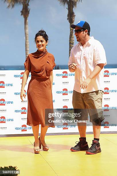 Actress Salma Hayek and Adam Sandler attend the "Grown Ups 2" photocall during The 5th Annual Summer Of Sony on April 18, 2013 in Cancun, Mexico.
