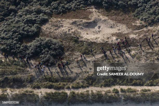 This aerial picture taken on September 16 from a police aircraft belonging to the French Police Aux Frontieres shows migrants wearing life jackets...