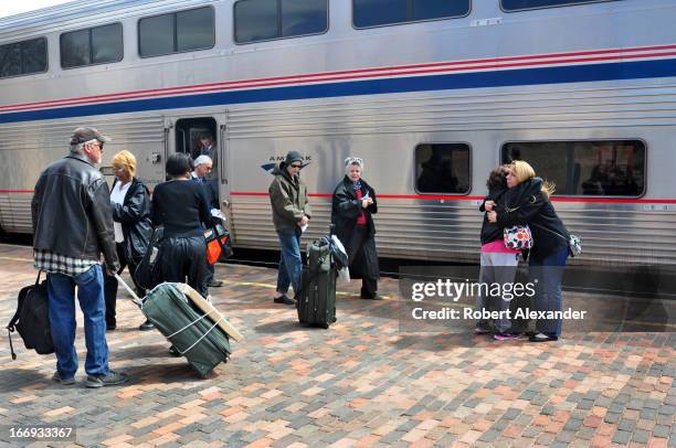 Train passengers prepare to board Amtrak's Southwest Chief at the Amtrak station in Lamy, New Mexico. The train runs daily between Los Angeles and...