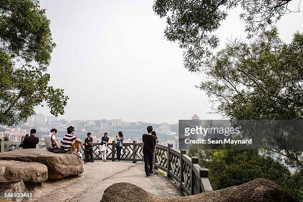 People pause to take in the view from the Wulao Peaks, which rise above the South Putuo Buddhist Temple on Xiamen Island.