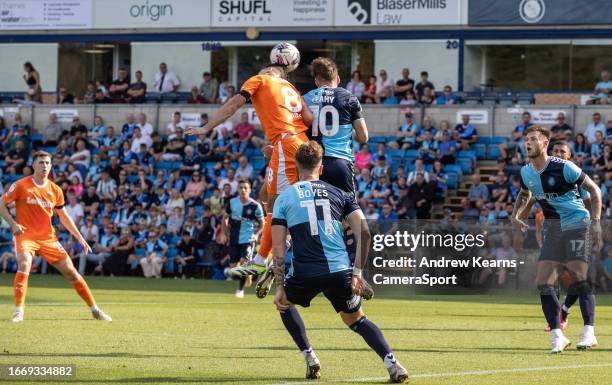 Blackpool's Albie Morgan competing in the air with Wycombe Wanderers' Luke Leahy during the Sky Bet League One match between Wycombe Wanderers and...