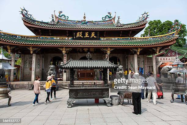 Worshipers pray and tourists take in the sights at South Putuo Buddhist Temple on a spring day in Xiamen.