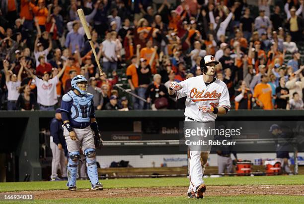Catcher Jose Molina of the Tampa Bay Rays looks on as Matt Wieters of the Baltimore Orioles flips his bat and follows his walk off grand slam to give...