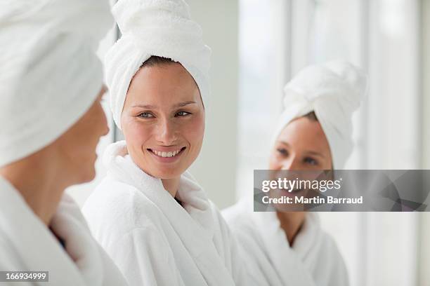 women in bathrobes and hair wrapped in towels at spa - woman with towel spa stock pictures, royalty-free photos & images