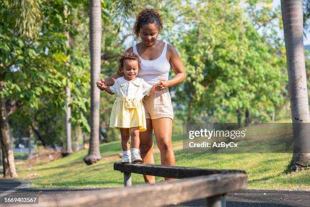 mom playing with their smiling children in the playground - cute college girl stock pictures, royalty-free photos & images