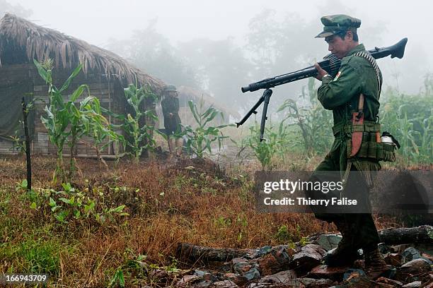 Soldier from the Kachin Independence Army carries a German made machine gun captured from the Burma army during a recent clash. With 6,000 troops,...