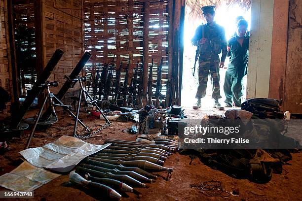 Kachin Independence Army soldiers display weapons, ammunitions and other items they seized from Burmese soldiers during an outburst of violent...