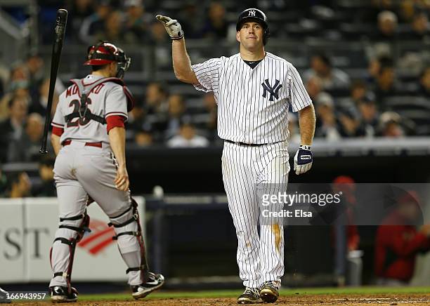 Kevin Youkilis of the New York Yankees reacts after striking out to end the inning as Miguel Montero of the Arizona Diamondbacks walks off the field...