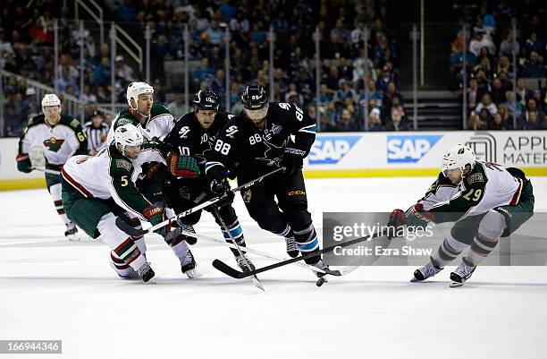 Brett Clark and Kyle Brodziak of the Minnesota Wild go for the puck against Andrew Desjardins and Brent Burns of the San Jose Sharks and Jason...