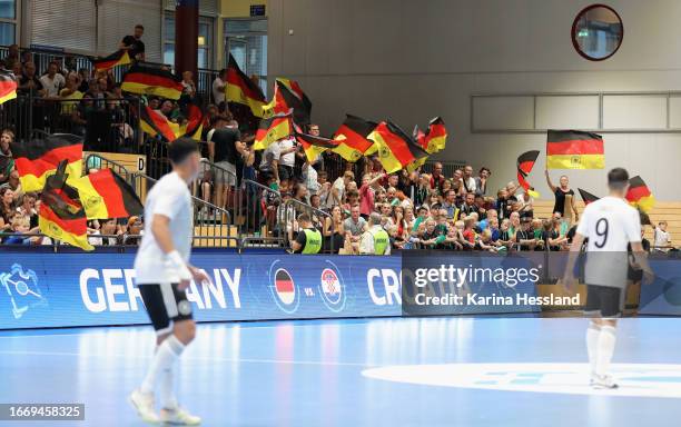 Fans celebrates with German flags at Richard-Hartmann-Halle on September 16, 2023 in Chemnitz, Germany.