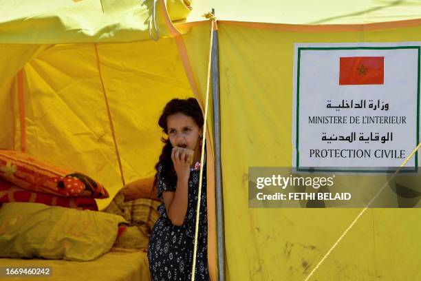 Girl looks out from a relief tent at a camp for locals displaced by a devastating earthquake in Amizmiz on September 16, 2023. The magnitude 6.8...