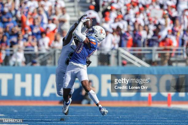 Wide receiver Eric McAlister of the Boise State Broncos grabs a pass over the top of defensive back C.J. Siegel of the North Dakota Fighting Hawks...