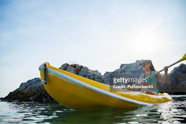 sian athletic woman on kayak at the sea. solo outdoor water sport and travel on summer holiday thailand. - similan islands stock pictures, royalty-free photos & images