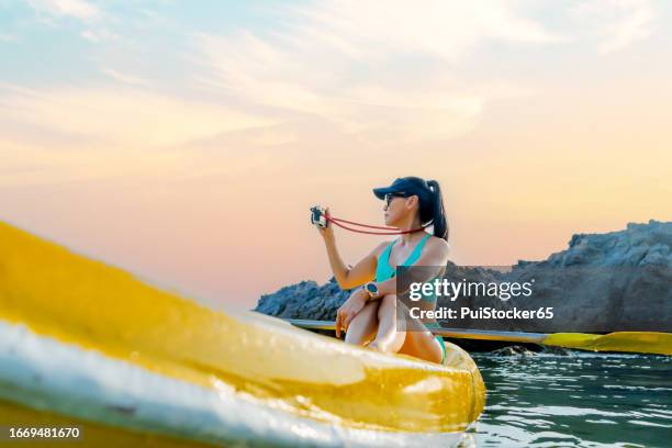 sian athletic woman on kayak at the sea. solo outdoor water sport and travel on summer holiday thailand. - similan islands stock pictures, royalty-free photos & images