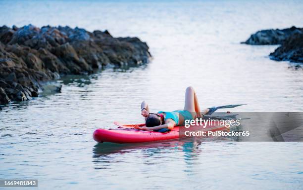 asian athletic woman on paddle board at the sea. solo outdoor water sport and travel on summer holiday thailand. - similan islands stock pictures, royalty-free photos & images