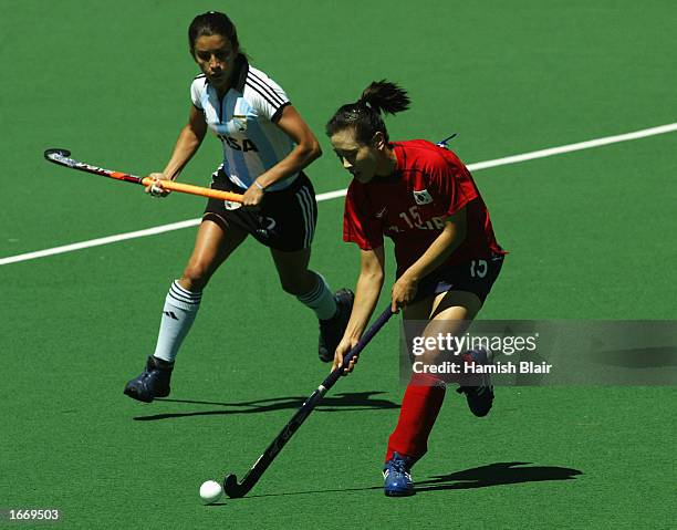 Eun Young Lee of Korea runs off Mariana Gonzalez Olivia of Argentina during the Women's World Cup Hockey match between Argentina and Korea at the...