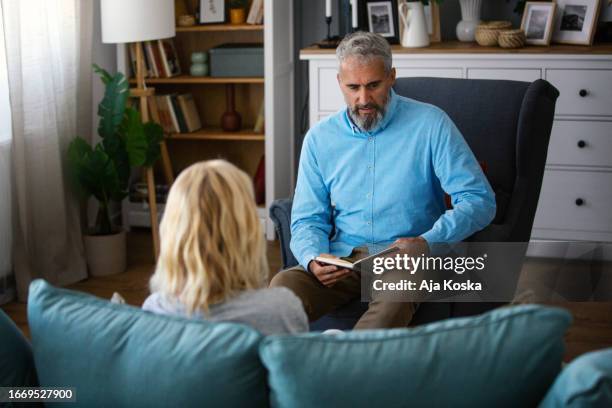 transformative conversations. - doctor with male patient reading notes stock pictures, royalty-free photos & images