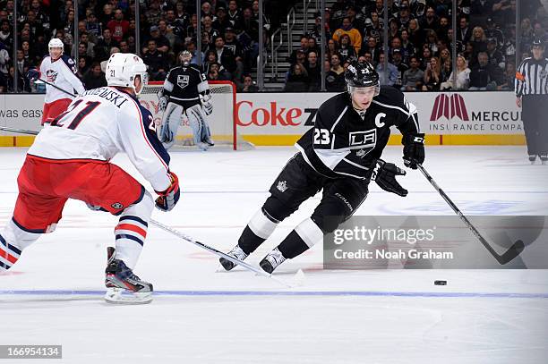 Dustin Brown of the Los Angeles Kings skates with the puck against James Wisniewski of the Columbus Blue Jackets at Staples Center on April 18, 2013...