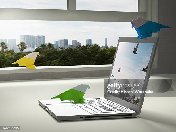 paper bird is tweeting with a laptop pc - origami asia stock pictures, royalty-free photos & images