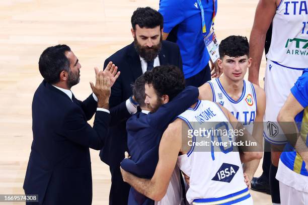 Luigi Datome of Italy is embraced by ead coach Gianmarco Pozzecco as he is substituted out in the fourth quarter during the FIBA Basketball World Cup...