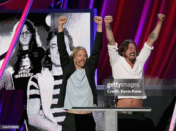 Musicians Taylor Hawkins and Dave Grohl speak onstage during the 28th Annual Rock and Roll Hall of Fame Induction Ceremony at Nokia Theatre L.A. Live...