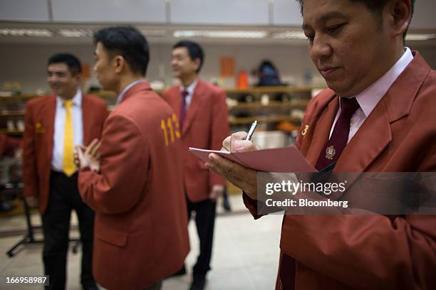 Trader writes down pricing notes in the trading hall of The Chinese Gold and Silver Exchange Society in Hong Kong, China, on Friday, April 19, 2013....