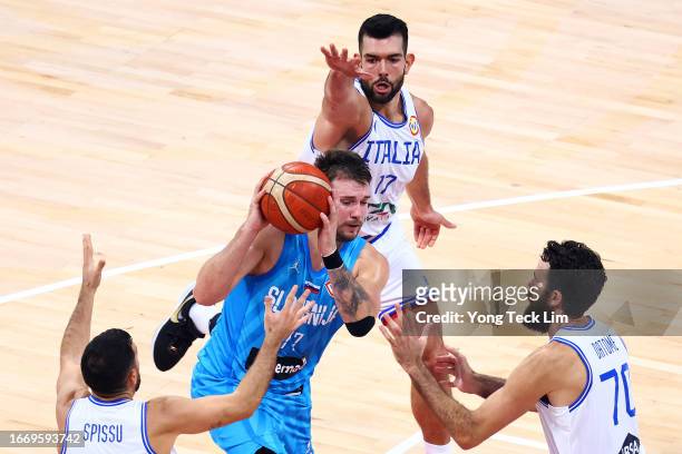 Luka Doncic of Slovenia drives against Marco Spissu , Giampaolo Ricci and Luigi Datome of Italy in the second half during the FIBA Basketball World...