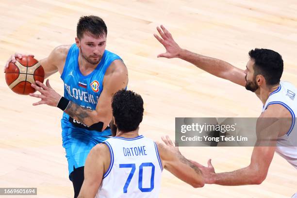 Luka Doncic of Slovenia controls the ball against Luigi Datome and Giampaolo Ricci of Italy in the second half during the FIBA Basketball World Cup...