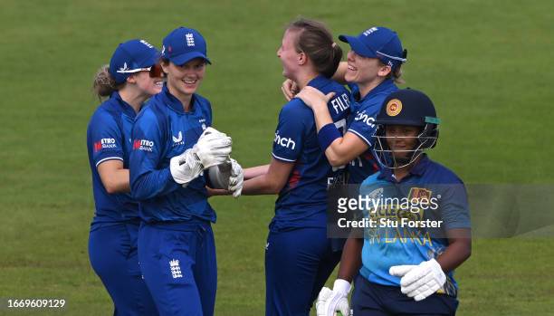 England bowler Lauren Filer celebrates with team mates after taking the wicket of batter Hasini Perera during the 1st Metro Bank ODI between England...