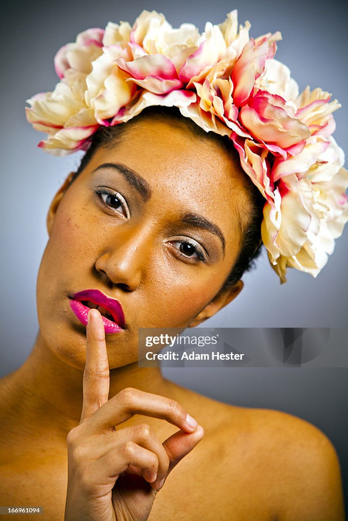 A young women wearing a floral head dress.