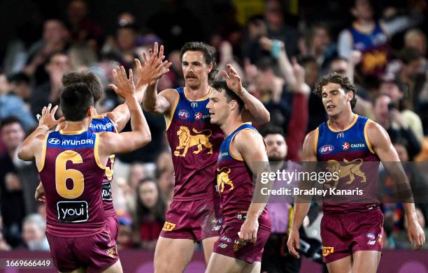 Joe Daniher of the Lions celebrates with team mates after kicking a goal during the Second Qualifying Final AFL match between the Brisbane Lions and...