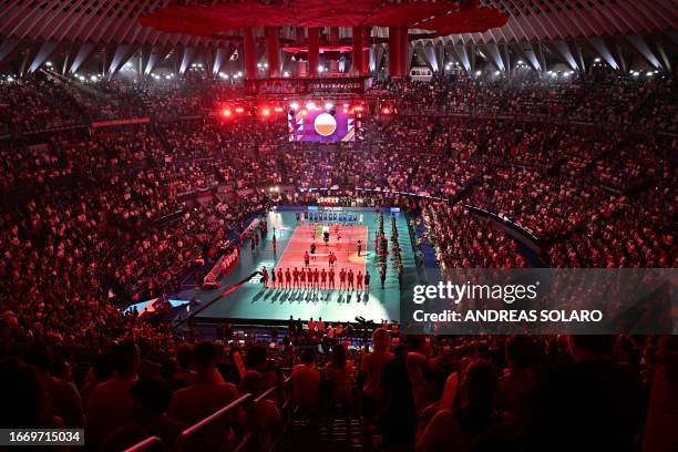 Italy's national volleyball team and Poland's national volleyball team stand during the national anthems ahead of the Men's EuroVolley 2023 European...