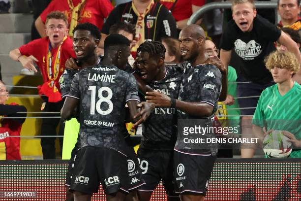 Metz's Swedish forward Joel Asoro celebrates with teammates after opening the scoring during the French L1 football match between RC Lens and FC Metz...