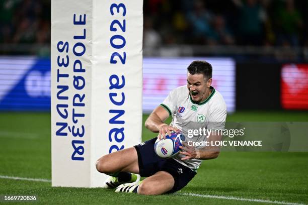 Ireland's fly-half Jonathan Sexton scores a try during the 2023 Rugby World Cup Pool B match between Ireland and Tonga at the Stade de la Beaujoire...